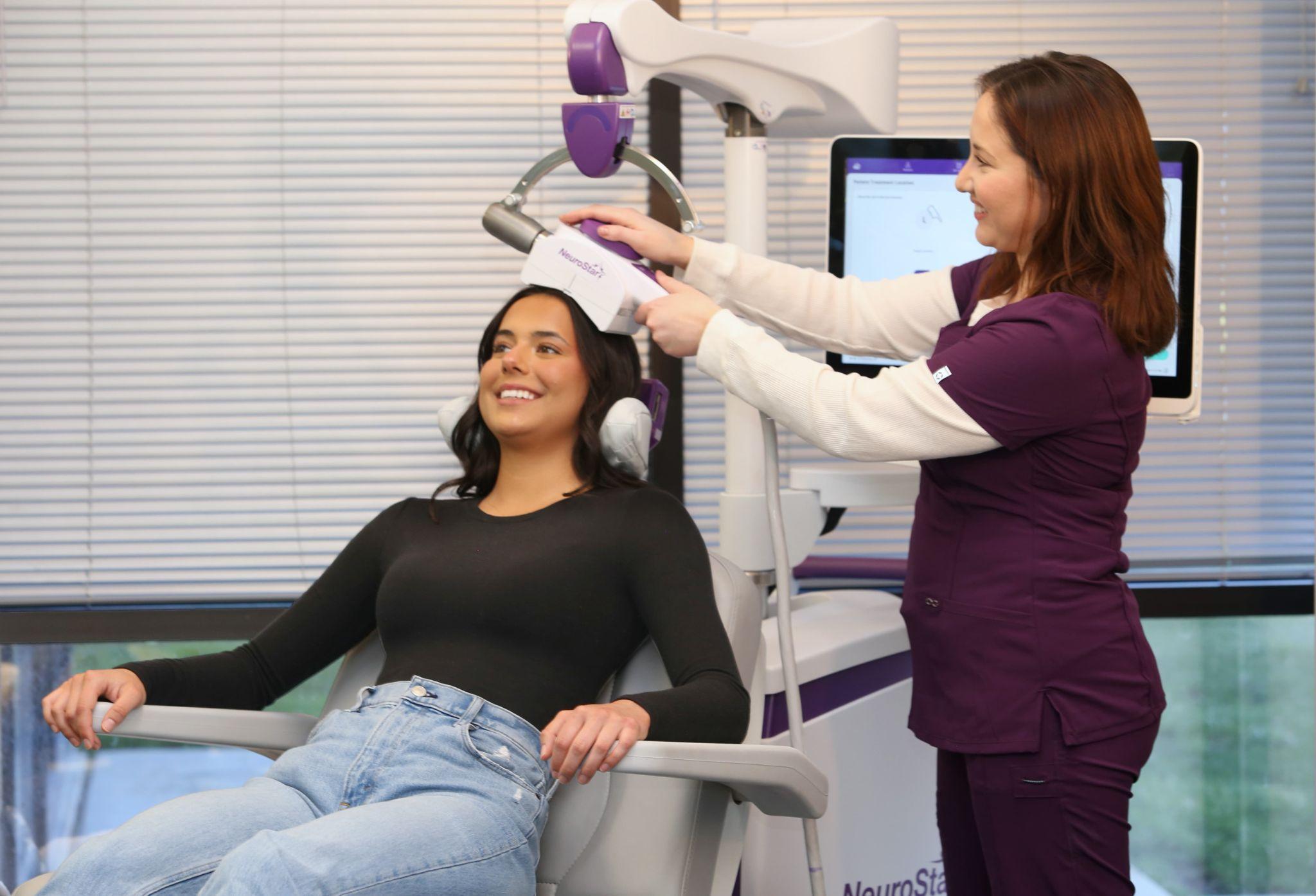 Doctor consulting with a teen patient, discussing whether TMS therapy is a safe treatment option